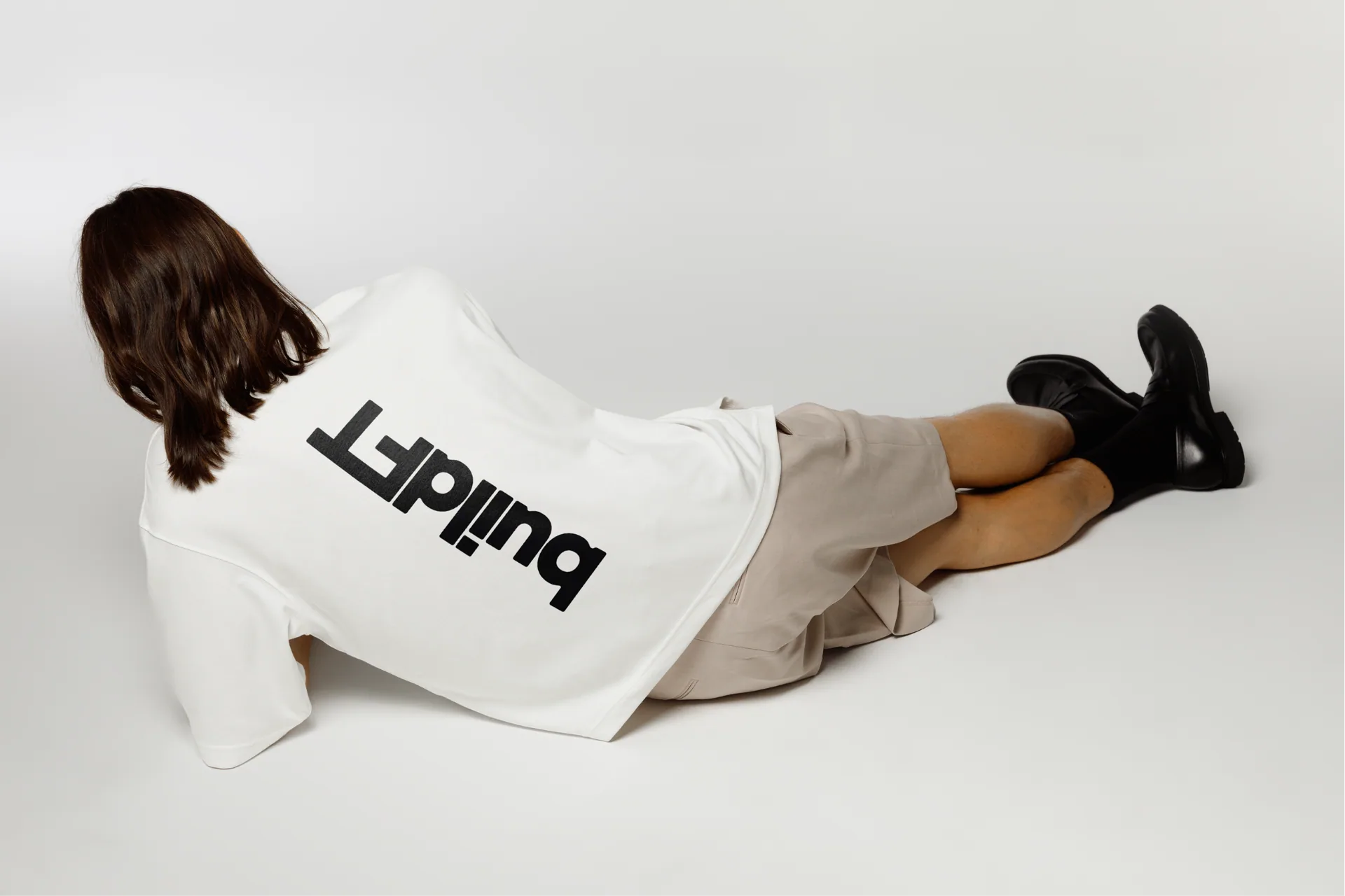 BuildFT branded white shirt photographed in studio.