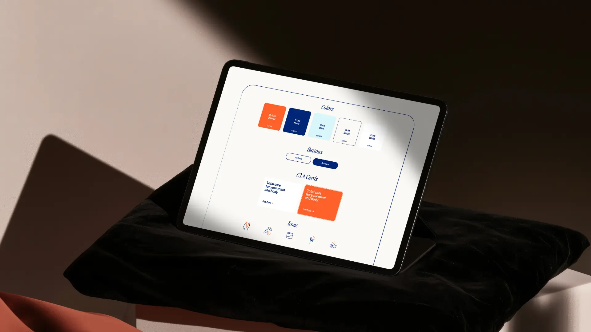 Tablet showing the Optum design pattern library — color tokens, button styles, CTA cards, and icons.