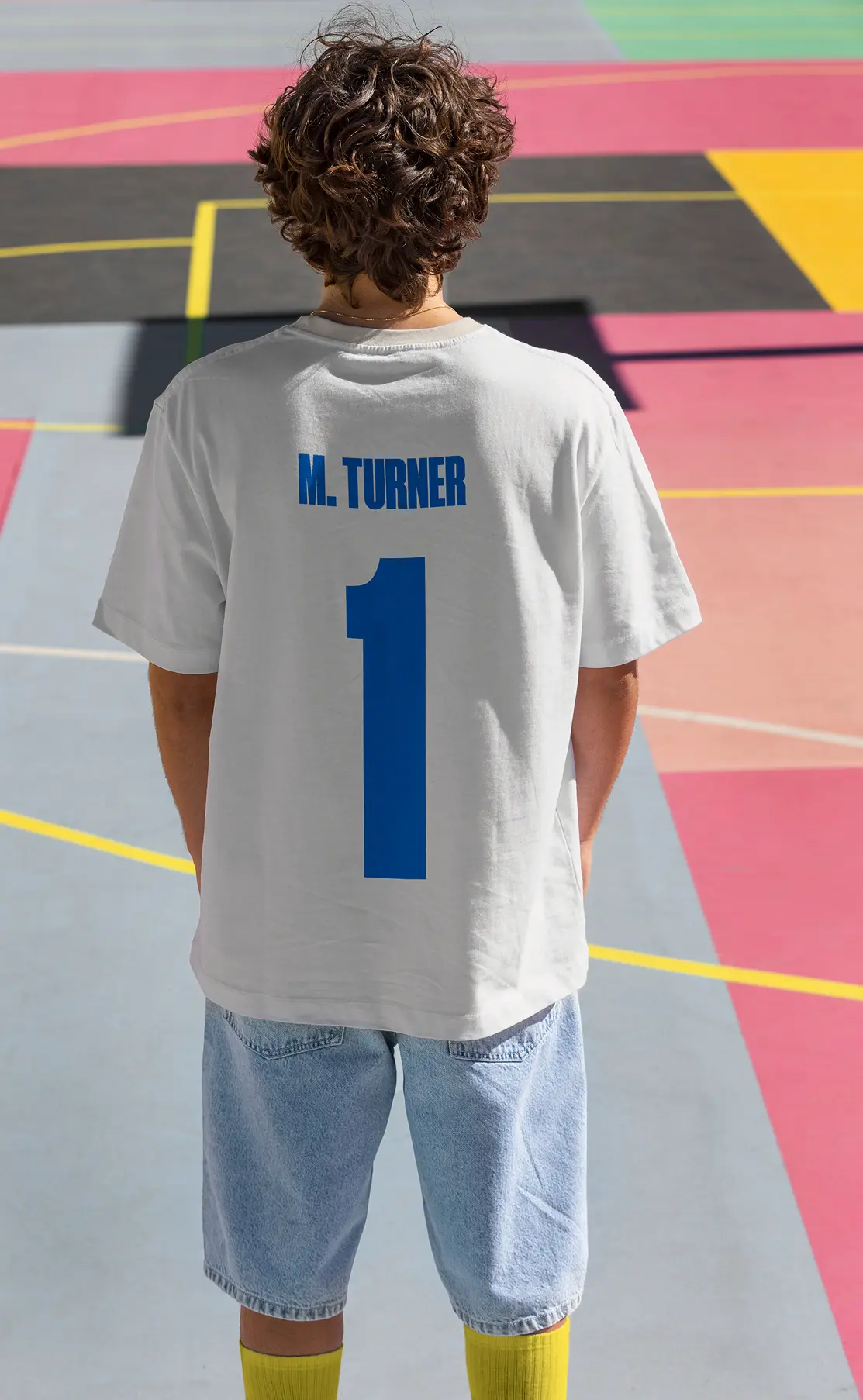 One Million Degrees jersey-style branded t-shirt on a colorful court.