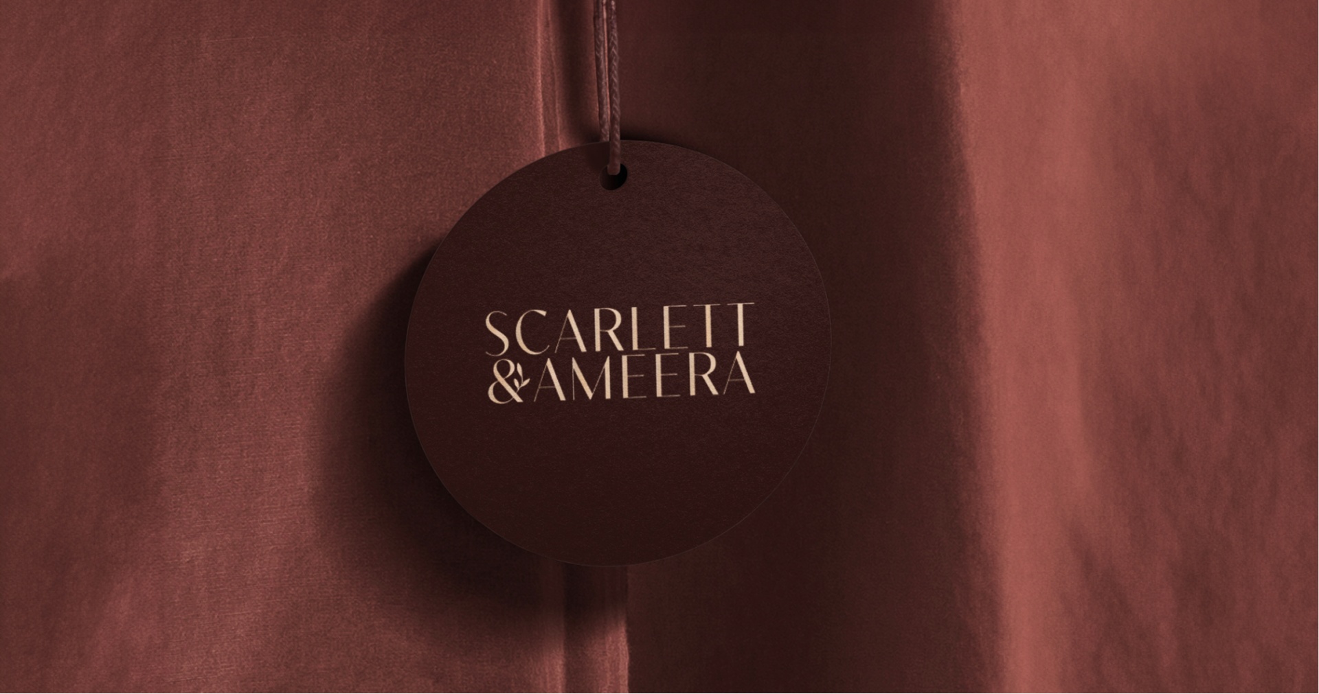 Scarlett&Ameera luxury sustainable fashion brand identity — hangtag on silk.